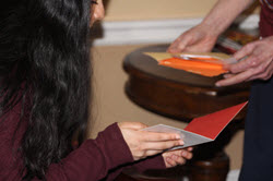Young adult woman looking at cards with an older man