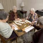 Four women playing a board game