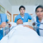 Doctors rushing a patient down a hospital corridor