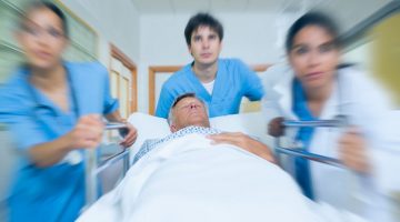 Doctors rushing a patient down a hospital corridor