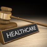 Healthcare sign sitting next to a gavel