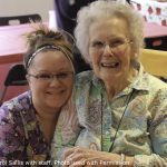 Carol Sallis in the dining room with a staff caregiver