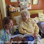 Jennifer Sallis reading to her mother in her nursing home room