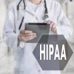 Doctor with chart different medical symbols and the word HIPAA
