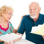 Older man and woman over whelmed with paper work