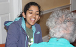 Young adult woman laughing with an older adult