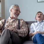 Senior laughing with young boy