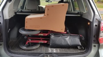SUV trunk with a wheelchair and steps to get into a car