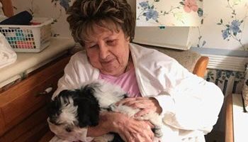 senior woman with puppy helps isolation