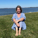 Author sitting outside by the ocean