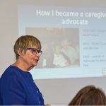 showing a woman presenting on how she became a caregiver advocate